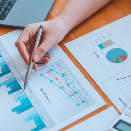 A meeting discussion over financial graphs, signaling risks from too many unpaid invoices.