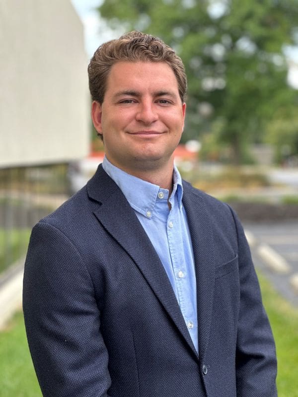 A photo Of Tyler Totin wearing a blue dress shirt and jacket.